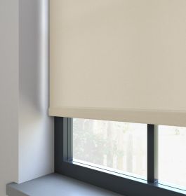 A beige dimout roller blind in a window