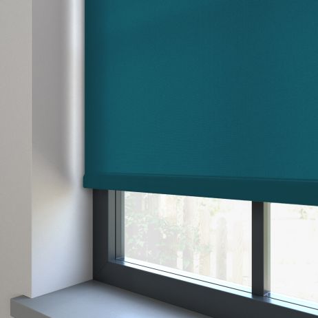 Our Burst Ocean Grean dimout roller blind in a living room window.