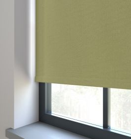 Our Amor Dried Sage Roller blind in a living room window.